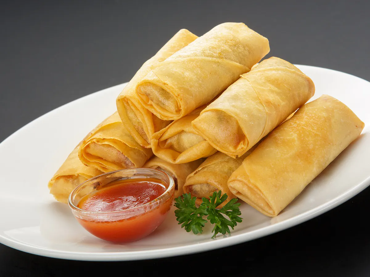 Crispy fried spring rolls served with sweet chili dipping sauce at Home Flavor, a Chinese Restaurant in Largo